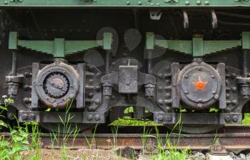 Black wheels of railway gun system. Soviet railroad artillery system details