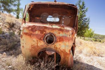 Abandoned rusted body of three-wheeled light commercial vehicle
