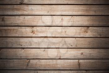 Background texture of dark wooden wall made of pine tree planks with central spot light illumination