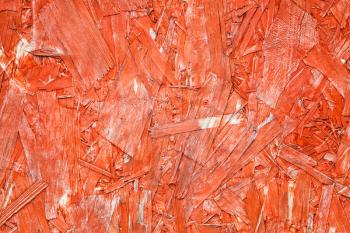 Bright red painted oriented strand board OSB. Sterling board background photo texture 