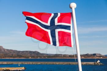 Flag of Norway waving over blue sky background