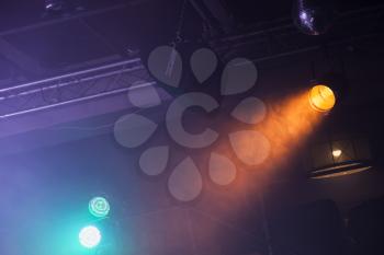 Spot lights over dark ceiling background, rock music concert stage illumination equipment