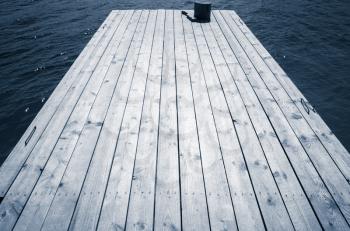 Empty old wooden pier perspective, blue toned photo