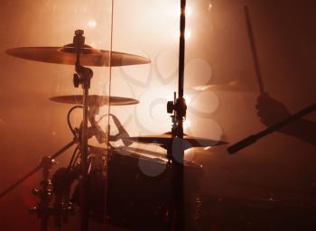 Live music photo background, rock drum set  with cymbals and blurred stage lights
