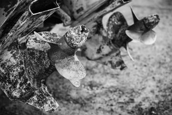 Old rusted propeller screws, grungy black and white photo