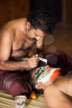 COCHIN, INDIA - MARCH 14: An unidentified actors make-up before the evening Kathakali performance on March 14, 2012 in Cochin, Kerala, India.