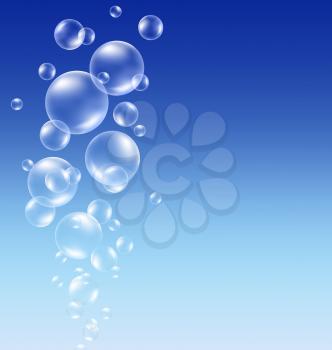 Transparent soap bubbles on blue background