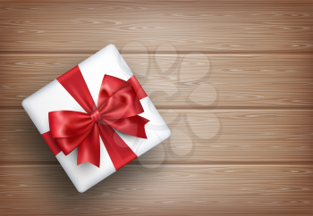 Present Gift Box with Bow on Wooden Background