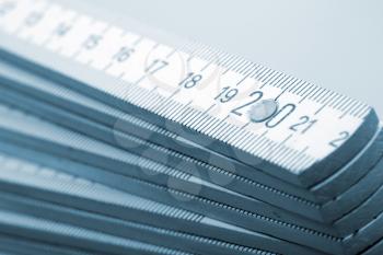 Closeup of wooden rulers. Toned in blue