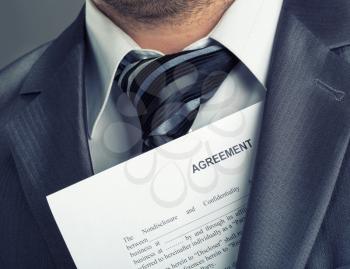 Closeup of businessman with agreement