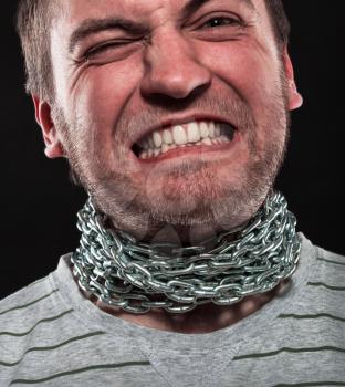 Screaming man with iron chain around neck