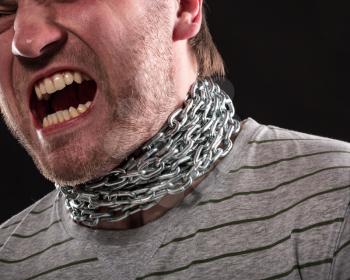 Screaming man with iron chain around neck