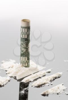 Cocaine and 10 dollars on grey background