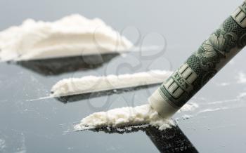 Cocaine lines and 10 dollars on grey background