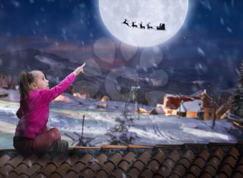 Girl sits on the roof in winter night