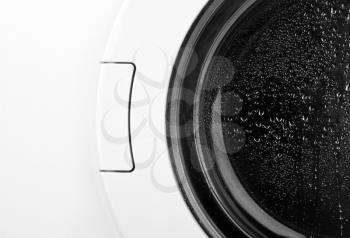 Close-up of washing machine door. In B/W