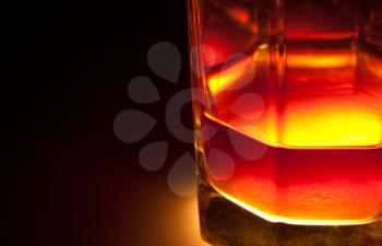Dark gold whiskey in glass. Close-up view