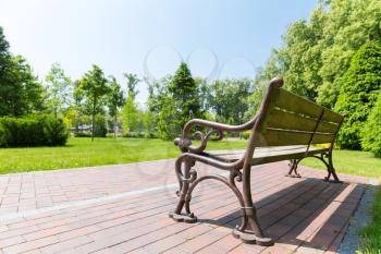 Bench in the park against the meadow