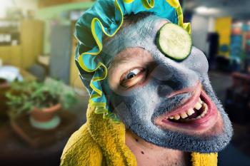 Insane man with face pack in home cosy interior