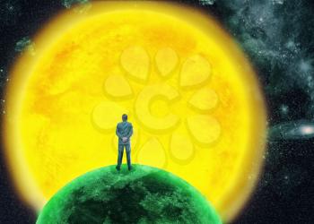 Businessman standing back on the planet in front of a big sun