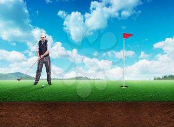 Businessman playing golf in open air