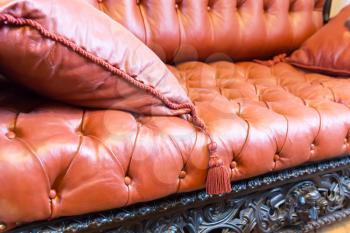 Macro of luxuroius leather-covered sofa with a pillow