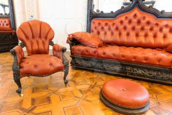Room with luxurious vintage leather-covered furniture
