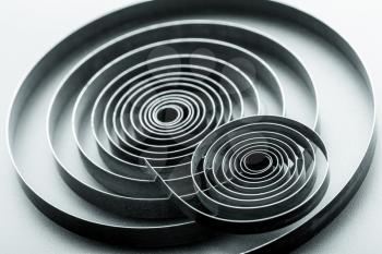 Abstract metallic spirals on grey background