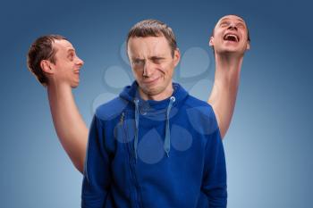 Concept of split personality, a man with three heads over blue