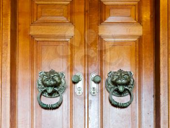 Close up of wooden doors with two metal knobs