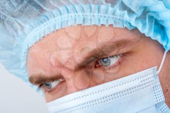 Portrait of sweat serious surgeon in surgical mask