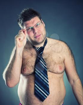 Serious shirtless man weard tie and glasses
