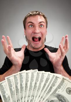 Portrait of very excited man with money