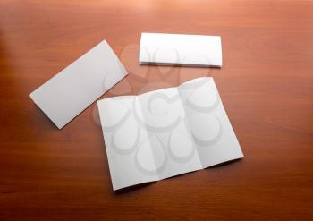 Three sheets of paper on a wooden table