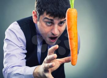 Bait metaphor. Man and carrot .