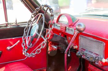 Chain rudder of a red vintage car closeup