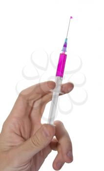 Hand holding a syringe with pink vaccine