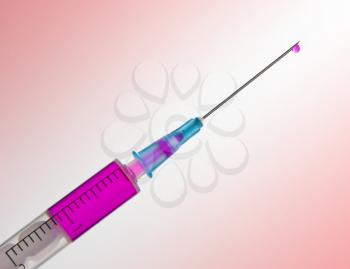 Syringe with pink vaccine and drop on the needle