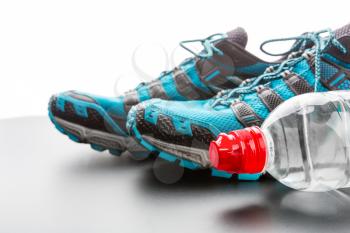 Closeup of sports runners and a bottle of water