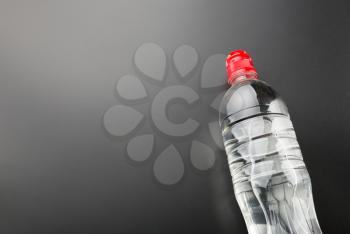 One plastic water bottle on grey background