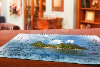 Calendar  with beautiful  landscape  lays on the table