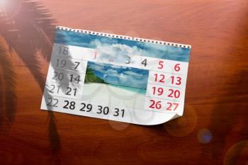 Calendar  with beautiful ocean landscape  lays on the table