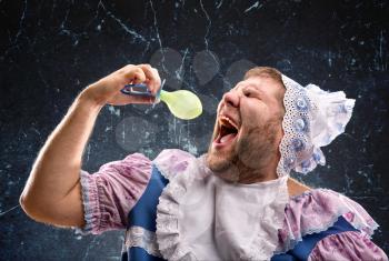 Crazy man sucking a pacifier  in studio