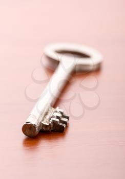 A closeup of old key on wooden background