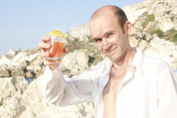 Man drinking cocktail on the beach