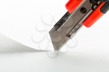 Office knife cutting a paper sheet