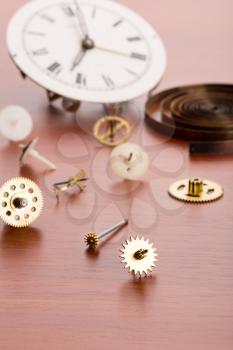Many clock details on wooden table