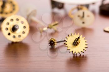 Different gears on the wooden table closeup