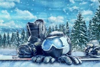Winter sport glasses, ski, helmet and gloves on winter forest background