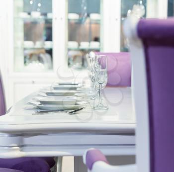 Served table with a kitchen tools in white and purple colors